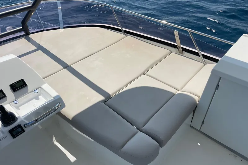  Yacht Photos Pics Luxurious sunbathing area on 2021 Prestige 460 yacht, featuring comfortable seating and ocean view.
