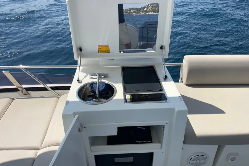  Yacht Photos Pics Prestige 460 yacht outdoor kitchen with sink and grill, 2021 model, on open sea.