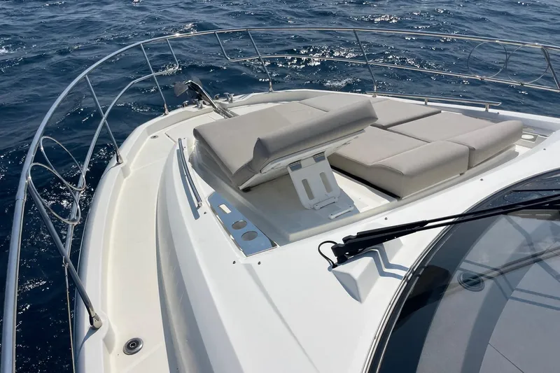  Yacht Photos Pics Prestige 460 yacht 2021 model with sun loungers on deck, cruising on open sea.