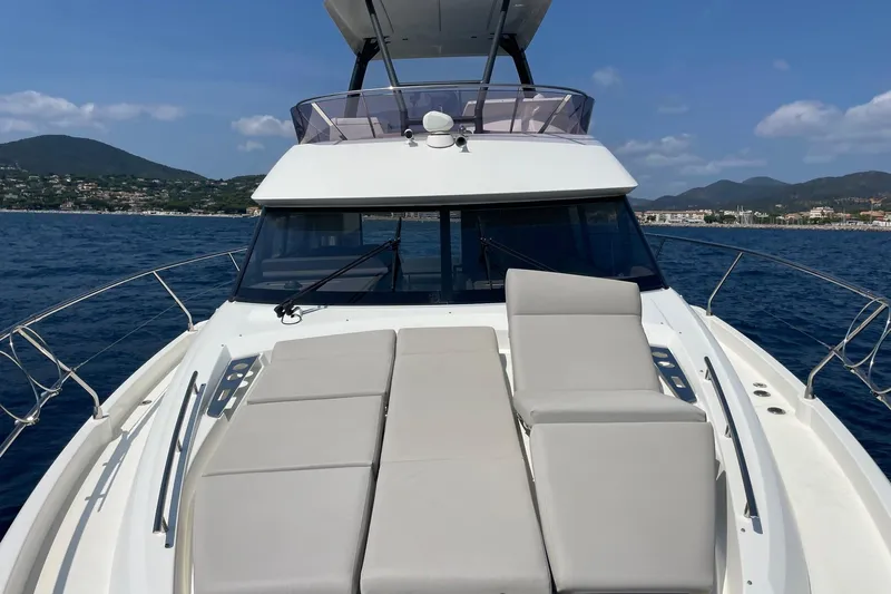  Yacht Photos Pics Prestige 460 yacht, 2021 model, cruising on blue waters with scenic mountain backdrop.