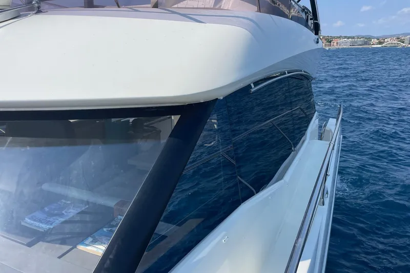  Yacht Photos Pics 2021 Prestige 460 yacht cruising on blue ocean waters, showcasing sleek design and luxury.