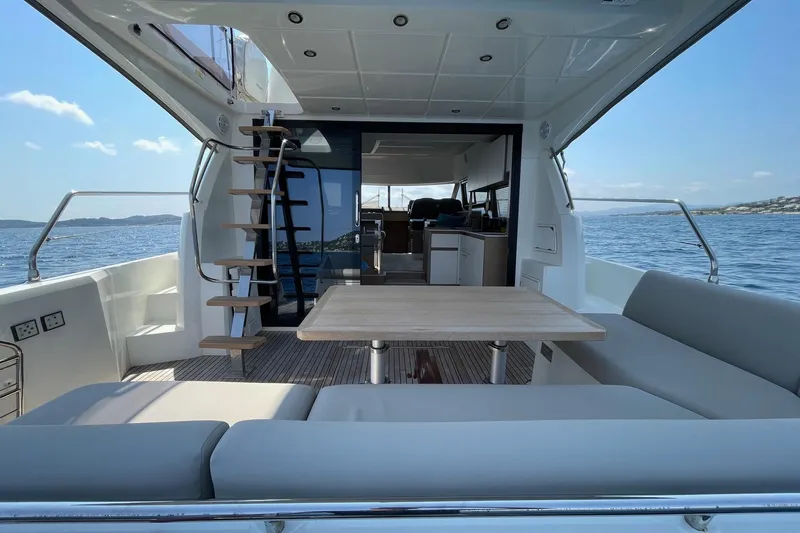  Yacht Photos Pics Luxurious 2021 Prestige 460 yacht interior with seating, table, and ocean view.