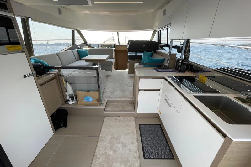  Yacht Photos Pics Luxurious interior of 2021 Prestige 460 yacht with modern kitchen and seating area.