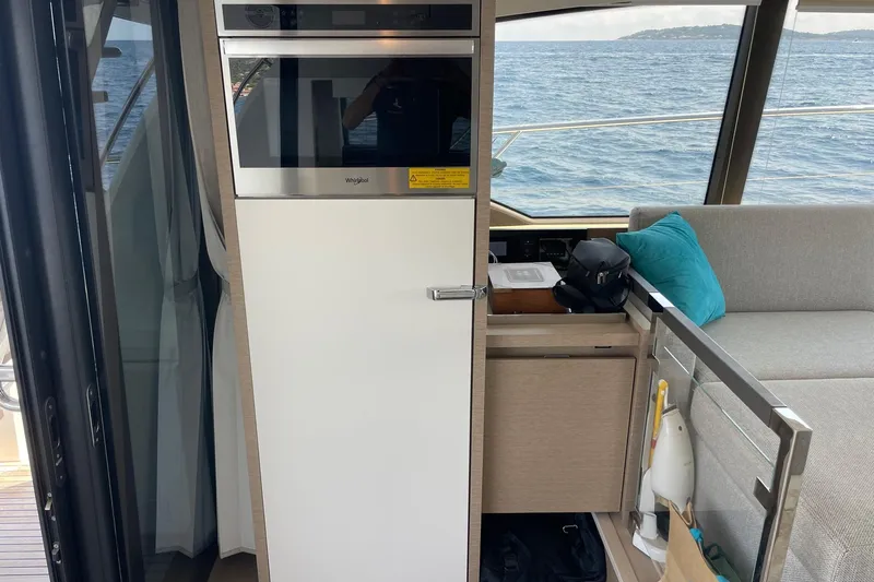  Yacht Photos Pics Modern kitchen area on 2021 Prestige 460 yacht with Whirlpool appliances and ocean view.