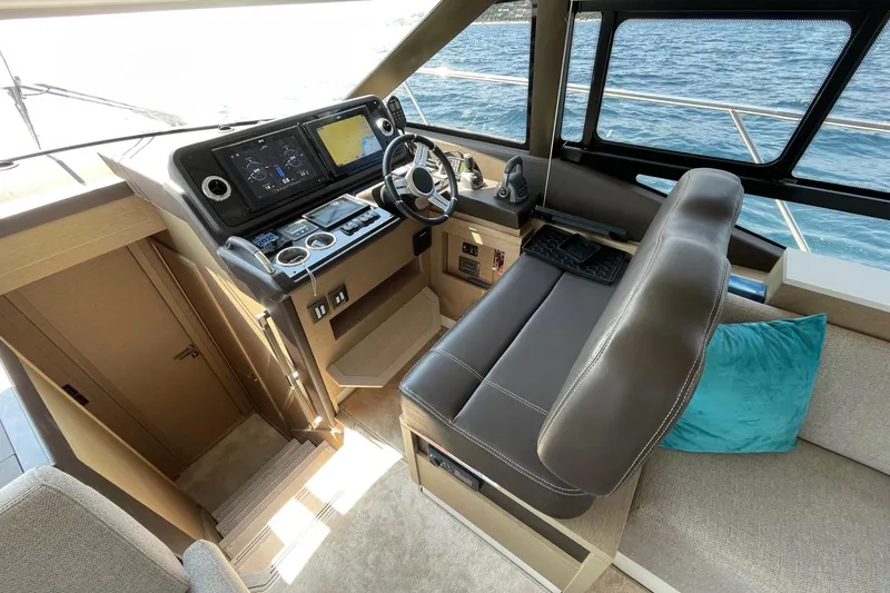  Yacht Photos Pics Interior helm of 2021 Prestige 460 yacht with modern controls and leather seating.