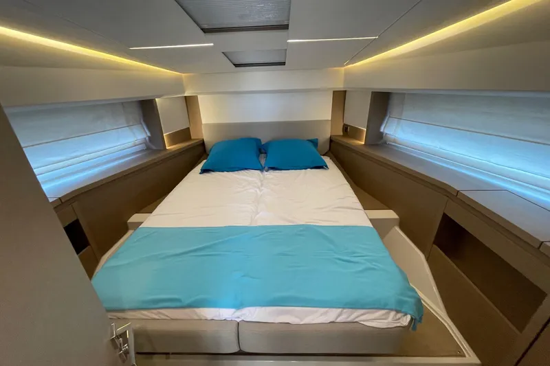  Yacht Photos Pics Luxurious bedroom interior of 2021 Prestige 460 yacht with modern design and ambient lighting.