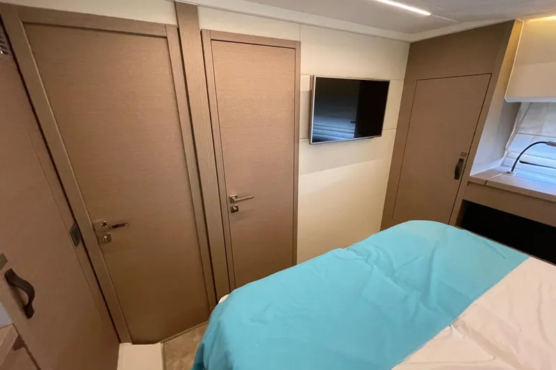  Yacht Photos Pics Interior of 2021 Prestige 460 yacht bedroom with TV and modern design.
