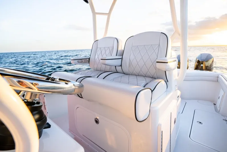  Yacht Photos Pics 2023 Yellowfin 34 Offshore boat interior with luxurious seating at sunset.