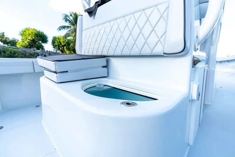  Yacht Photos Pics 2023 Yellowfin 34 Offshore boat interior with seating and storage compartment.
