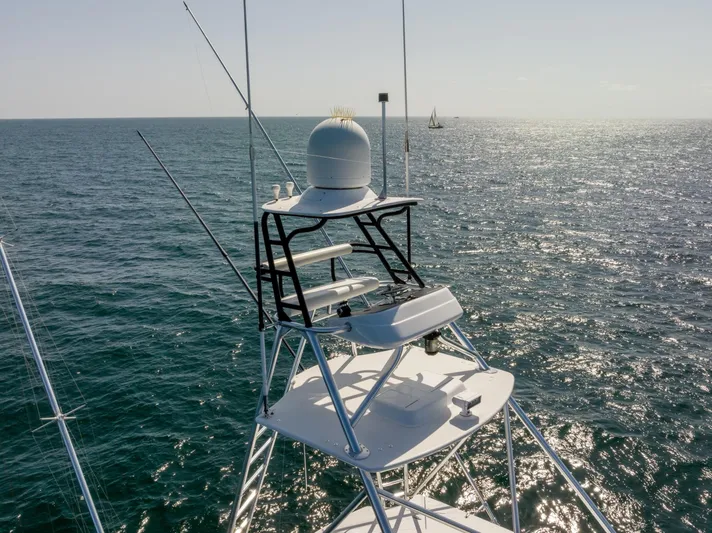Resilient Yacht Photos Pics 2018 Hatteras GT70 yacht tower with ocean backdrop, showcasing radar and navigation equipment.