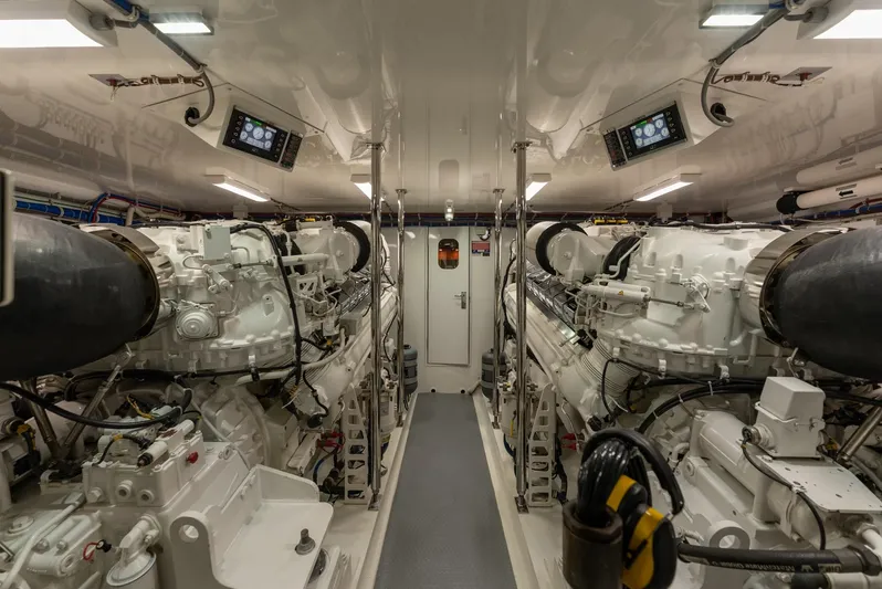 Resilient Yacht Photos Pics Engine room of 2018 Hatteras GT70 yacht, featuring dual engines and control panels.