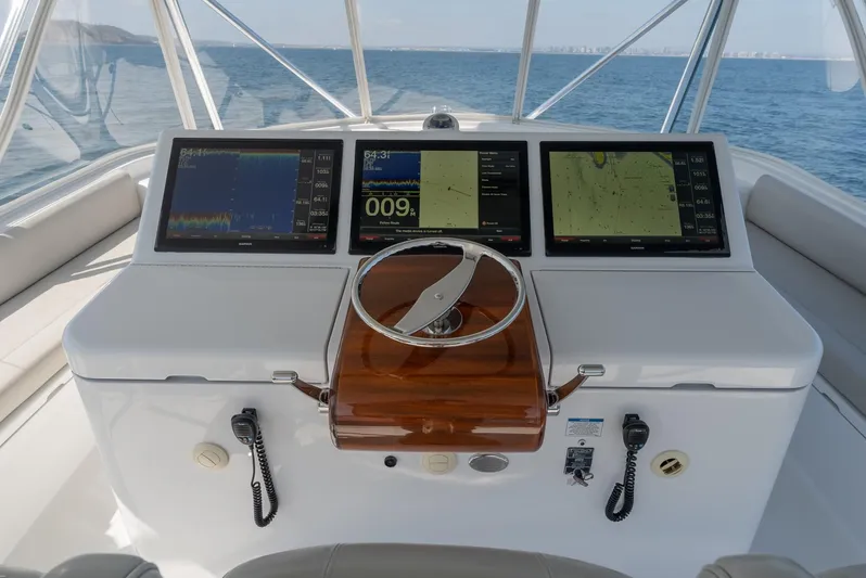 Resilient Yacht Photos Pics Helm of 2018 Hatteras GT70 yacht with navigation screens and steering wheel.