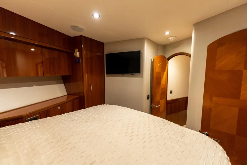 Resilient Yacht Photos Pics Luxurious cabin interior of 2018 Hatteras GT70 yacht with wood finishes and TV.