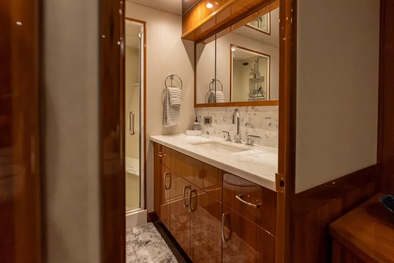 Resilient Yacht Photos Pics Luxurious bathroom in 2018 Hatteras GT70 yacht with elegant wood cabinetry and modern fixtures.