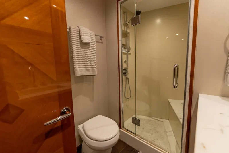 Resilient Yacht Photos Pics Luxurious bathroom in 2018 Hatteras GT70 yacht with glass shower and modern fixtures.