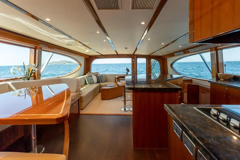 Resilient Yacht Photos Pics Luxurious interior of 2018 Hatteras GT70 yacht with ocean view and elegant wood finishes.
