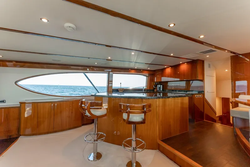 Resilient Yacht Photos Pics Luxurious interior of 2018 Hatteras GT70 yacht with elegant wood finishes and ocean view.