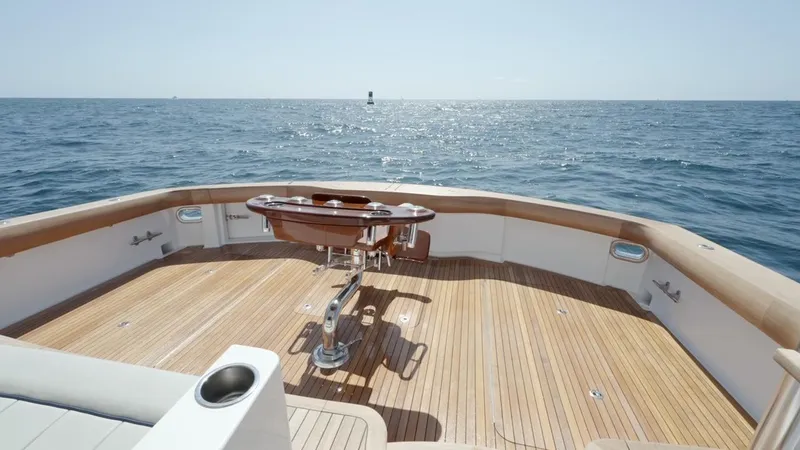 Resilient Yacht Photos Pics 2018 Hatteras GT70 yacht deck with wooden flooring, overlooking the ocean.