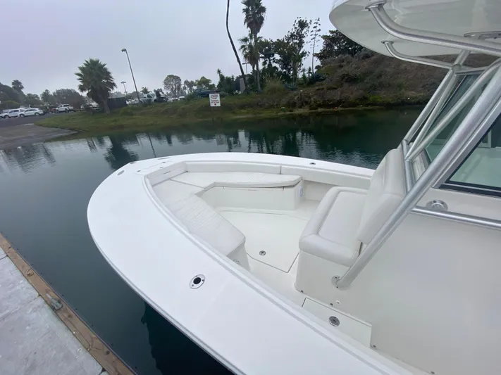  Yacht Photos Pics 2007 Regulator 29 FS boat docked by a calm waterway.