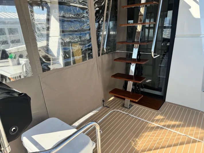 King's Ransom Yacht Photos Pics Interior view of 2017 Fountaine Pajot MY 37 yacht with wooden steps and seating.