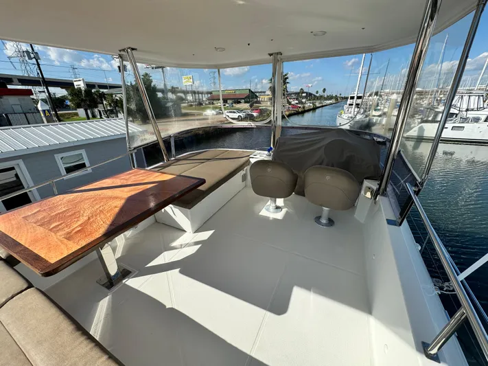 King's Ransom Yacht Photos Pics 2017 Fountaine Pajot MY 37 yacht deck with seating and table, marina view.