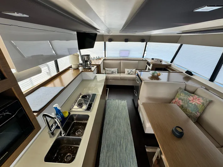 King's Ransom Yacht Photos Pics Luxurious interior of 2017 Fountaine Pajot MY 37 yacht with modern kitchen and seating area.
