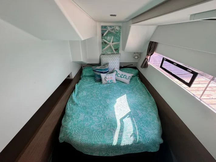 King's Ransom Yacht Photos Pics Cozy bedroom in 2017 Fountaine Pajot MY 37 yacht with ocean-themed decor.