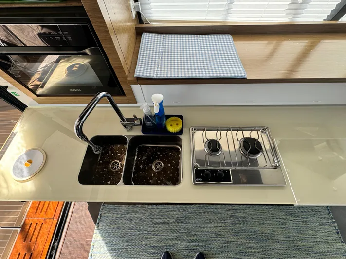 King's Ransom Yacht Photos Pics Modern kitchen in 2017 Fountaine Pajot MY 37 yacht with dual sink and stove.