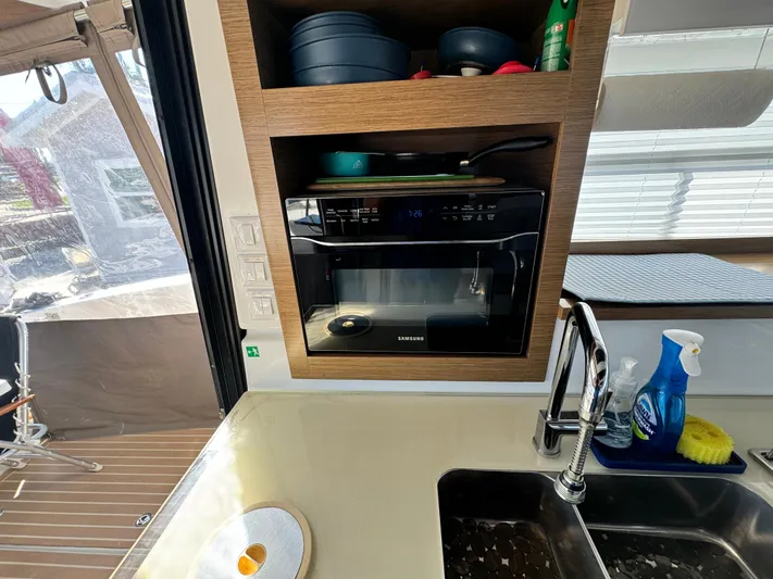 King's Ransom Yacht Photos Pics Modern kitchen area on 2017 Fountaine Pajot MY 37 yacht with microwave and sink.