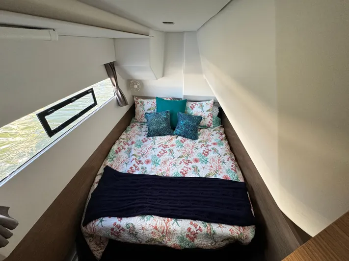 King's Ransom Yacht Photos Pics Cozy bedroom in 2017 Fountaine Pajot MY 37 yacht with floral bedding and window view.