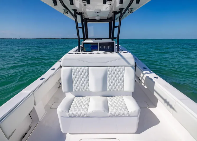  Yacht Photos Pics 2025 Invincible 36 Open Fisherman boat interior with white seating, on clear blue water.