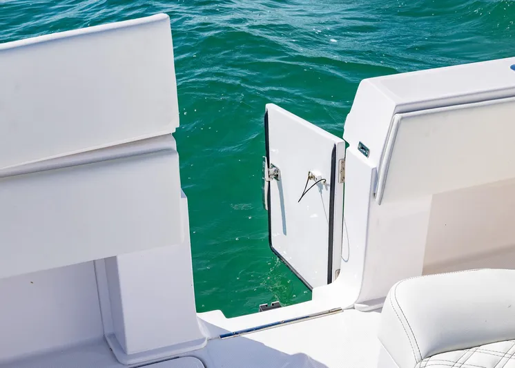  Yacht Photos Pics 2025 Invincible 36 Open Fisherman boat with open side door on turquoise water.