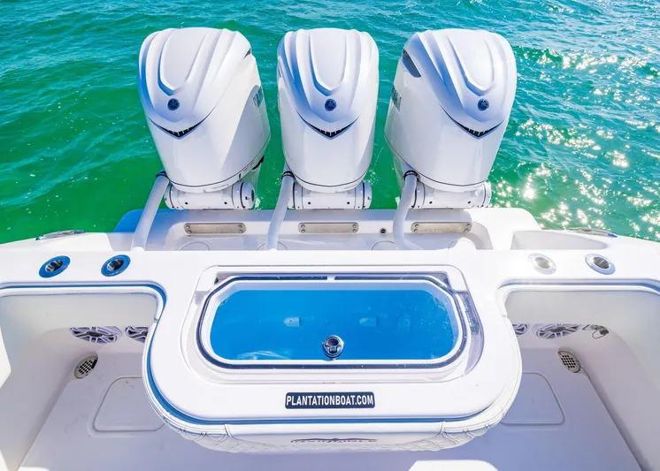  Yacht Photos Pics 2025 Invincible 36 Open Fisherman boat with triple outboard engines on clear water.