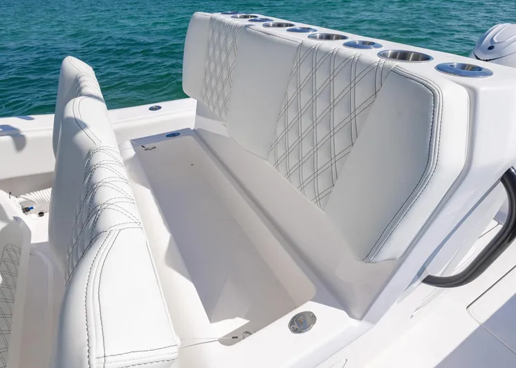  Yacht Photos Pics 2025 Invincible 36 Open Fisherman boat with white cushioned seating and cup holders.