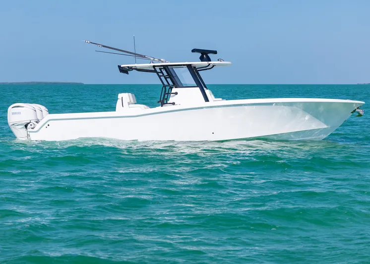  Yacht Photos Pics 2025 Invincible 36 Open Fisherman boat cruising on clear blue water.