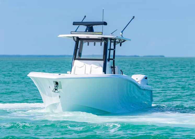  Yacht Photos Pics 2025 Invincible 36 Open Fisherman boat cruising on turquoise waters.