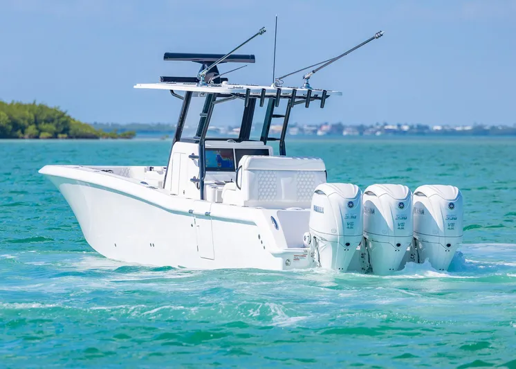 Yacht Photos Pics 2025 Invincible 36 Open Fisherman boat cruising on clear blue water.