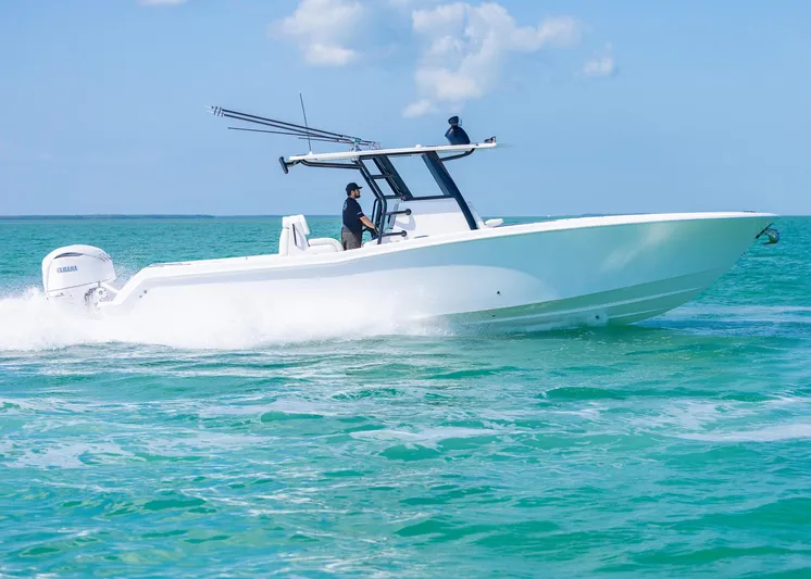  Yacht Photos Pics 2025 Invincible 36 Open Fisherman boat cruising on clear blue water.