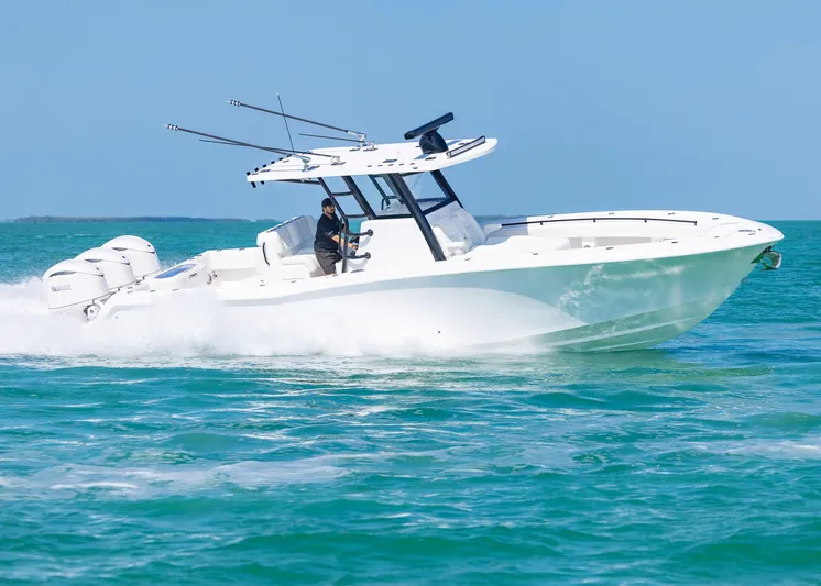  Yacht Photos Pics 2025 Invincible 36 Open Fisherman boat cruising on turquoise waters.