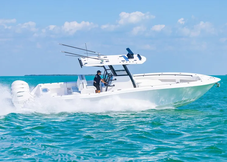  Yacht Photos Pics 2025 Invincible 36 Open Fisherman boat cruising on clear blue water.