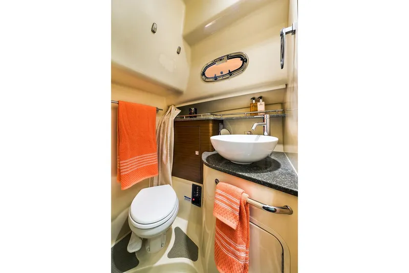  Yacht Photos Pics Manufacturer Provided Image: 2021 Boston Whaler 345 Conquest bathroom with modern sink and orange towels.