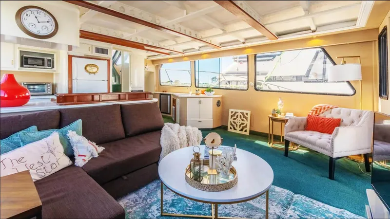 The West Star Yacht Photos Pics Luxurious 1994 Shaw 57 yacht interior with modern decor and large windows.