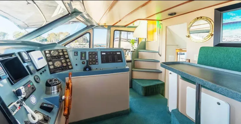 The West Star Yacht Photos Pics Luxurious 1994 Shaw 57 yacht interior with helm, seating, and staircase.