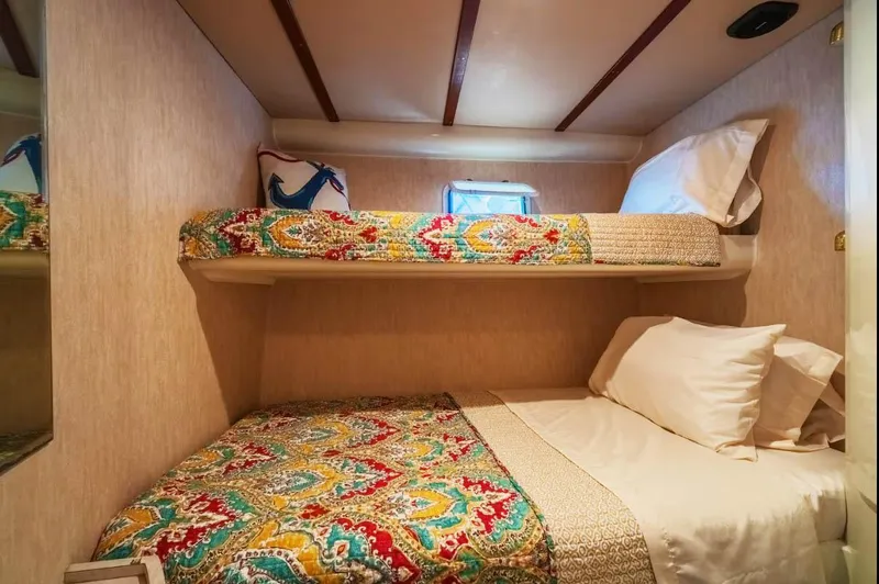 The West Star Yacht Photos Pics Cozy Shaw 57 yacht cabin with colorful bedding, 1994 model.