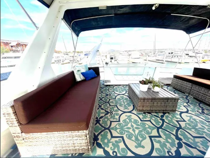 The West Star Yacht Photos Pics Luxurious Shaw 57 yacht interior with stylish seating and patterned rug, 1994 model.