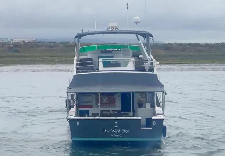 The West Star Yacht Photos Pics A 1994 Shaw 57 yacht named "The West Star" on calm waters.