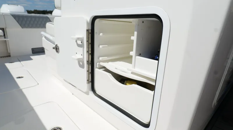 Engine Warranty X Trailer Yacht Photos Pics Open storage compartment on 2020 Invincible 37 Catamaran, showcasing interior shelving.