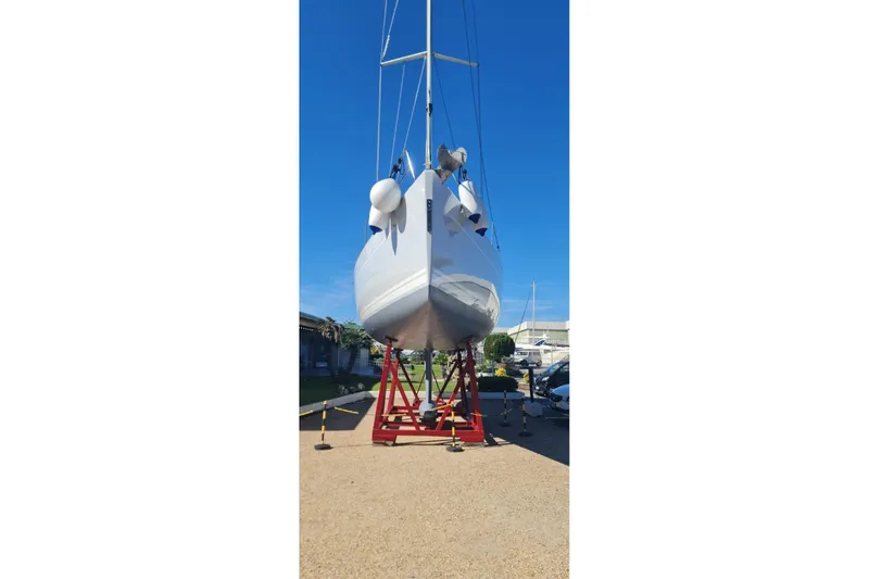  Yacht Photos Pics 2010 Hanse 400e sailboat on red stands, viewed from the front, under clear blue sky.