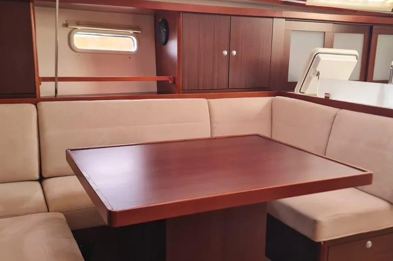  Yacht Photos Pics Interior of 2010 Hanse 400e yacht with wooden table and beige seating.