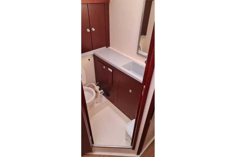  Yacht Photos Pics Bathroom interior of 2010 Hanse 400e yacht with wooden cabinets and white fixtures.